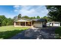 Charming brick home with a covered front porch, a well-maintained lawn, and a paved driveway at 3423 S Hwy 127 Hwy, Hickory, NC 28602