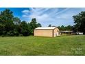 Large outbuilding is adjacent to the home, with a garage door and a well-manicured lawn at 3423 S Hwy 127 Hwy, Hickory, NC 28602