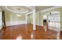 Elegant dining room featuring hardwood floors, decorative columns, and natural light at 35115 Carnation Ln, Fort Mill, SC 29707