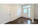 Bright entryway with hardwood flooring, a closet, and a glass-paneled front door that lets in natural light at 3807 Blazeprince Dr, Charlotte, NC 28215