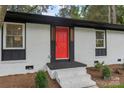 Inviting front entrance featuring a red door, gray trim, and freshly landscaped front yard at 3900 Colebrook Rd, Charlotte, NC 28215