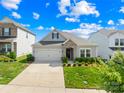Charming single-Gathering home with well-manicured lawn, stone accents, and a convenient two-car garage, under bright blue skies at 3938 Isenhour Rd, Kannapolis, NC 28081