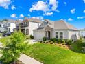 Beautiful single-Gathering home featuring manicured lawn, stone accents, and a two-car garage on a sunny day at 3938 Isenhour Rd, Kannapolis, NC 28081