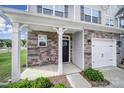 Inviting front entry with stone accents and a well-maintained facade, highlighting the home's architectural details at 4003 Rothwood Ln, Harrisburg, NC 28075