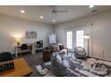 Versatile living area with an abundance of light, stylish decor, and access to the outdoor space at 4637 Willow Glen Rd, Harrisburg, NC 28075