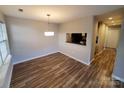 Inviting dining area featuring modern lighting, vinyl floors and a pass-through to the kitchen at 5003 Sharon Rd # Q, Charlotte, NC 28210