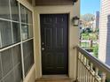 Charming front door with exterior light fixture, railing, and a glimpse of the neighborhood at 5003 Sharon Rd # Q, Charlotte, NC 28210