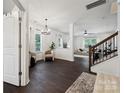 Bright living room featuring dark floors, white walls, modern chandelier, and lots of natural light at 5113 Saddleback Dr, Mount Holly, NC 28120