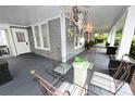 Relaxing front porch with a glass table, cushioned chairs, and elegant hanging decor at 616 N Deal Ave, Newton, NC 28658