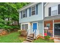 Charming townhome with blue siding, shutters, and a bright blue front door at 6401 Windsor Gate Ln, Charlotte, NC 28215