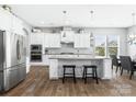 Bright kitchen with stainless steel appliances, granite countertops, central island, and sleek white cabinets at 6535 Bridgemoor Dr, Indian Trail, NC 28079