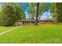 Charming single-story home with a well-maintained lawn and mature trees at 7022 Lakeside Dr, Charlotte, NC 28215