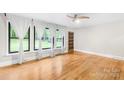 Bright living room featuring hardwood floors, white trim, and natural light at 7022 Lakeside Dr, Charlotte, NC 28215
