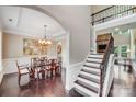 Elegant dining room open to the foyer, features a decorative chandelier and hardwood floors at 8070 Clems Branch Rd, Indian Land, SC 29707