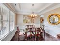 Open dining area with chandelier, large picture window and crown molding at 8070 Clems Branch Rd, Indian Land, SC 29707