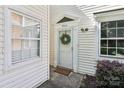 Welcoming front entrance featuring a white door with wreath accent and sidelight windows at 8510 Castle Pine Ct, Charlotte, NC 28226