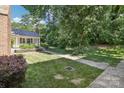 Lush front yard with mature trees and landscaping enhances the property's curb appeal at 8510 Castle Pine Ct, Charlotte, NC 28226