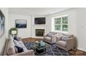 Bright living room features a fireplace, ample seating, and natural light from the window at 8510 Castle Pine Ct, Charlotte, NC 28226