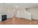 Bright living room with wood floors and cozy fireplace, creating a warm and inviting atmosphere at 8524 Emerald Fern Way, Charlotte, NC 28214