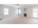 Spacious living room has neutral decor, a cozy fireplace, and ample natural light at 9641 Bellamy Nw Pl, Concord, NC 28027