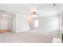 Open-concept living space with staircase, neutral tones, and abundant natural light at 9641 Bellamy Nw Pl, Concord, NC 28027