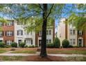 View of townhomes, showcasing the brick accents, well-kept lawns, and neat landscaping at 9651 Bailey Rd, Cornelius, NC 28031