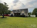 Traditional home with a well-maintained lawn and landscaped front yard, offering a serene curb appeal at 13219 Asbury Chapel Rd, Huntersville, NC 28078