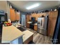 Well-lit kitchen featuring stainless steel appliances, wood cabinets, and a sink with counter space at 13219 Asbury Chapel Rd, Huntersville, NC 28078