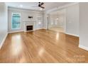 Spacious living room featuring hardwood floors, a fireplace, and ample natural light at 1326 Crown Ridge Dr, Fort Mill, SC 29708