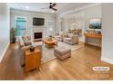 Bright, staged living room with hardwood floors, fireplace, and a seamless flow to the dining area at 1326 Crown Ridge Dr, Fort Mill, SC 29708