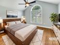 Stylishly staged main bedroom with vaulted ceiling, neutral tones, and a large window for natural light at 1326 Crown Ridge Dr, Fort Mill, SC 29708