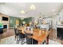 Bright and airy dining area with modern lighting, hardwood floors, and open-concept design at 15515 Laverack Ln, Davidson, NC 28036