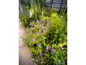 Charming garden with a variety of colorful flowers and lush greenery creating a peaceful outdoor space at 15515 Laverack Ln, Davidson, NC 28036