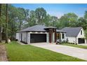 Inviting single-Gathering home with a well-kept lawn, stylish garage door, and a contemporary front entrance design at 1626 Burtonwood Cir, Charlotte, NC 28212