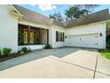 This single Gathering home features an attached garage, convenient driveway, and inviting front porch for welcoming guests at 167 Logan Crossing Dr, Davidson, NC 28036