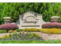 Entrance sign to the Tuscany neighborhood, featuring lush landscaping and a decorative stone monument at 1812 Sutter Creek Dr, Waxhaw, NC 28173