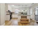 Bright kitchen with stainless steel appliances, a center island, and hardwood floors at 1821 Bonnie Ln, Charlotte, NC 28213