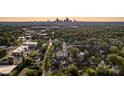 Aerial view of 2011 Hamorton Place, Charlotte, surrounded by lush greenery, with the city skyline in the background at 2011 Hamorton Pl, Charlotte, NC 28205