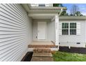 Close-up of the front porch and door with light gray siding and white trim at 2025 Slater Rd, Charlotte, NC 28216