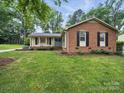 Well-maintained brick home with green lawn and manicured landscaping at 2026 Knell Dr, Charlotte, NC 28212