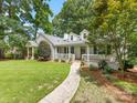 Beautifully landscaped front yard leading to a charming home with a covered front porch at 2112 Chatham Ave, Charlotte, NC 28205