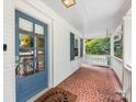 Charming front porch with swing and mosaic tile flooring, creating a welcoming entrance at 2112 Chatham Ave, Charlotte, NC 28205
