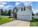 Beautiful home with a two-car garage, manicured lawn, brick accents and a welcoming entrance at 220 Otman Ct, Rock Hill, SC 29732