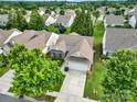 Aerial view of house showing the two-car garage, and landscaped yard in a tree-lined community at 2213 Hartwell Ln # 84, Indian Land, SC 29707