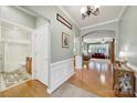Light and airy hallway with hardwood floors leading to the living room and bathroom at 2213 Hartwell Ln # 84, Indian Land, SC 29707