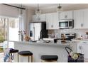 Well-lit kitchen showcases stainless steel appliances, white cabinets, and a spacious island at 2238 Endeavor Run, Charlotte, NC 28269