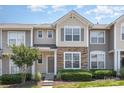 Charming townhome exterior with stone accents, tidy landscaping, and a welcoming entrance at 230 Dawn Mist Ln, Fort Mill, SC 29708