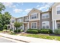 Inviting townhome community showcasing well-maintained landscaping and charming exteriors under a bright sky at 230 Dawn Mist Ln, Fort Mill, SC 29708