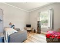 Comfortable living room area with cozy seating, lamp, and hardwood floors at 238 N Depot St, Albemarle, NC 28001