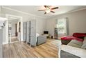 Cozy living room featuring a ceiling fan and plenty of natural light at 238 N Depot St, Albemarle, NC 28001